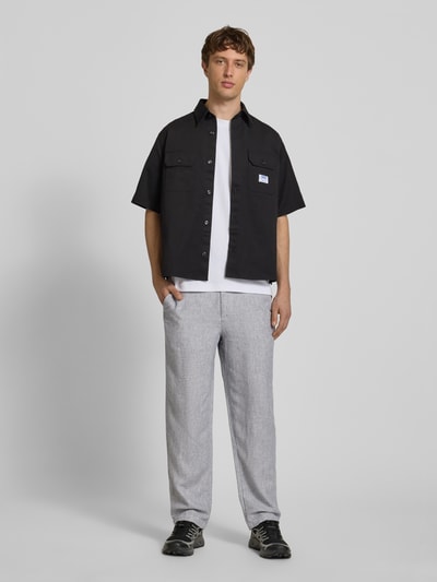 Mannermodel draagt Leinenhose mit Bindegürtel Modell 'KARL MYKONOS' van Jack & Jones, mix van linnen en viscose, relaxed fit, met knoop- en ritssluiting, strikceintuur, steekzakken voor, strookzak aan de achterkant, bandwijdte maat M 41 cm, binnenbeenlengte maat M 78 cm, kleur lichtgrijs, textuur fijn, casual uitstraling. Ganzkörperansicht von vorne.