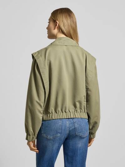 Frauenmodel trägt Jacke mit Reverskragen Modell 'GEZAVO' von ICHI in Olivgrün mit Zweireiher und Pattentaschen, Rückenansicht, Regular-Fit, Rückenlänge 54 cm, Schulterbreite 46 cm, Brustweite 60 cm, Ärmellänge 62 cm, Ganzkörperansicht Rückansicht.