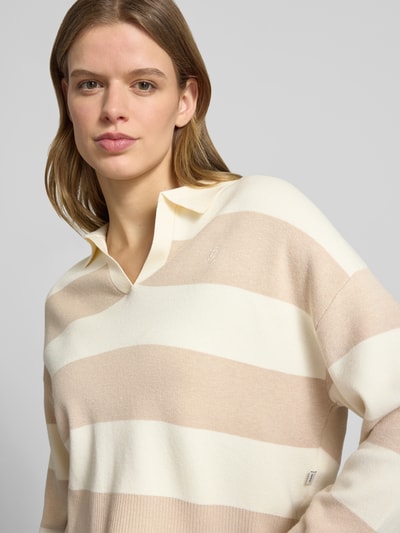 Frauenmodel trägt Strickpullover mit Polokragen von Guess Jeans in Beige und Creme, Viskose-Mix, Lockerer-Schnitt, Nahaufnahme Oberkörper.