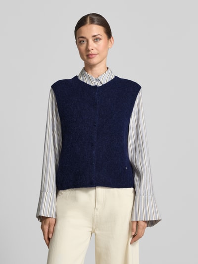 Frauenmodel trägt Regular Fit Cardigan aus elastischem Alpaka-Mix mit Knopfleiste von MOS MOSH, dunkelblau, ärmellos, strukturierte weiche Textur, Kombi mit heller Hose und gestreifter Bluse, Damen Cardigan, Ganzkörperansicht von vorne.