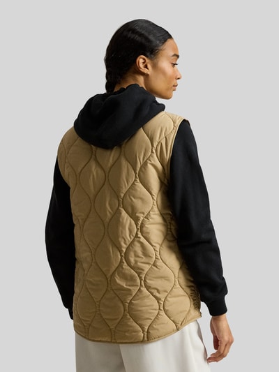 Vrouwenmodel draagt Regular Fit Steppweste met borstzak van Polo Ralph Lauren, effen beige en zwart, gewatteerde structuur, rugaanzicht.