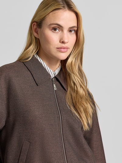 Frauenmodel trägt Regular Fit Blazer mit Reißverschluss von MORE & MORE, brauner Farbton, Umlegekragen, Eingrifftaschen, Mix mit Viskose-Anteil, Nahaufnahme Oberkörper.