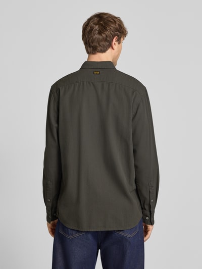 Męski model nosi Regular Fit Freizeithemd aus reiner Baumwolle von G-Star Raw, oliwkowa zieleń, kołnierzyk typu kent, listwa guzikowa, krój regular fit, bawełna, długość tyłu w rozmiarze M: 74 cm, szerokość ramion w rozmiarze M: 45 cm, długość rękawów w rozmiarze M: 67 cm, widok z tyłu pełnej sylwetki.