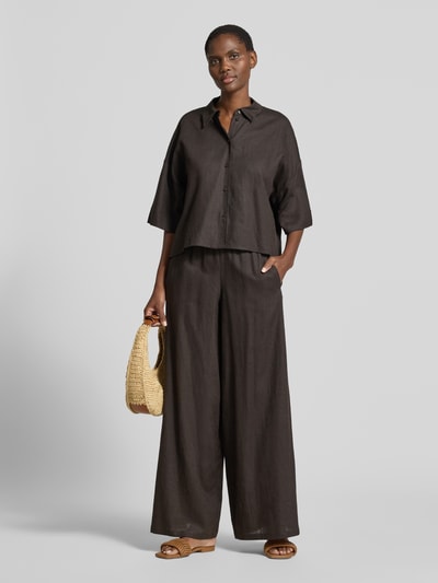 Frauenmodel trägt Relaxed Fit Bluse aus Leinen-Viskose-Mix von Drykorn, dunkelbraun, Knopfleiste, Kentkragen, Ganzkörperansicht von vorne.