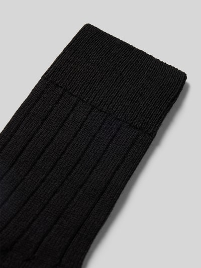 Produktfoto, Strümpfe aus Schurwollmischung Modell 'Teppich im Schuh' von FALKE in Schwarz, Rippenstruktur, verstärkte Belastungszonen, gepolsterte Sohle