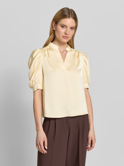 Frauenmodel trägt Blusenshirt mit Puffärmeln Modell 'Roella' von Neo Noir aus Satin im Gerader-Schnitt mit Serafino-Kragen, Ganzkörperansicht von vorne.