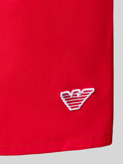 Produktfoto, Straight Fit Badeshorts mit Logo-Detail von Emporio Armani in leuchtendem Rot, glatte Textur, gesticktes Logo, elastischer Bund, Tunnelzug