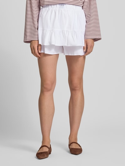 Frauenmodel trägt Ausgestellter Skort aus Leinen-Baumwoll-Mix Modell 'PIPPA' von VILLA SOPHIE in Weiß, mit lockerer Struktur, Ganzkörperansicht von vorne.