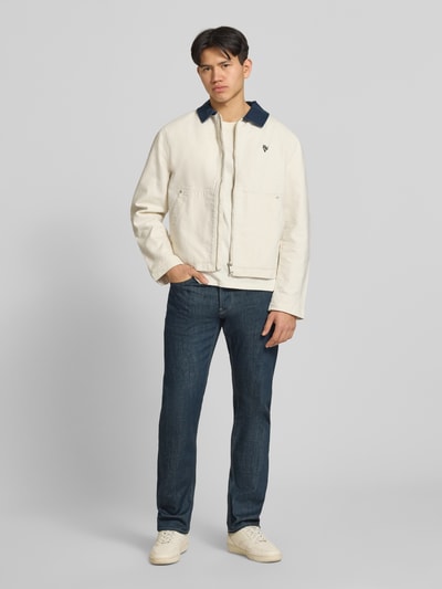 Männermodel trägt Slim Tapered Fit Jeans Modell 'Streem' von G-Star Raw aus Reine Baumwolle, dunkelblau, Eingrifftaschen, Ganzkörperansicht von vorne