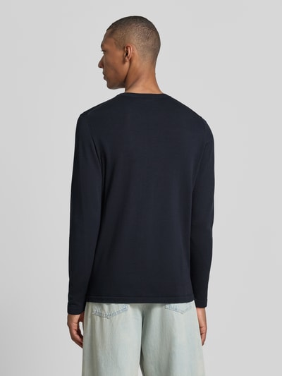 Männermodel trägt Slim Fit Langarmshirt reine Baumwolle von DRYKORN in zwart met ribboordjes, Ronde hals, Ganzkörperansicht Rückansicht, Ruglengte maat M 70 cm, Mouwlengte maat M 70 cm.