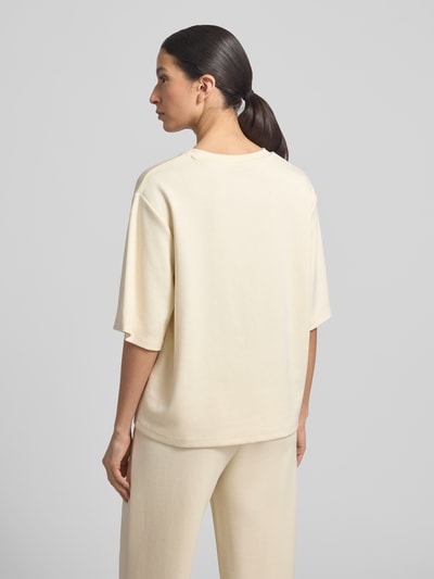 Kobiece modelka nosi T-Shirt mit Rundhalsausschnitt od Soyaconcept, kremowy kolor, relaxed fit, modal, widok całej sylwetki z tyłu.