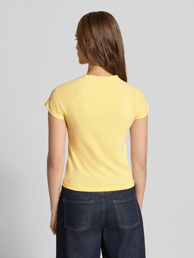 Frauenmodel trägt T-Shirt mit Raglanärmeln Modell 'KATINKA' von NOISY MAY®, Gelbton, Baumwoll-Elasthan-Mix, Ganzkörperansicht Rückansicht.