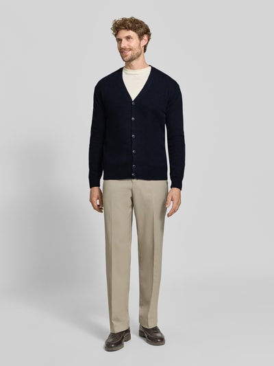 Męski model nosi kardigan z mieszanki bawełny, krój regular fit, dekolt w serek, listwa guzikowa, Model 'KARL' od Casual Friday, Długość tyłu w rozmiarze M: 70 cm, Długość rękawów w rozmiarze M: 70 cm, widok całej sylwetki z przodu.