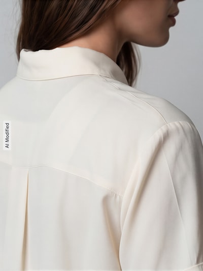 Frauenmodel trägt Regular Fit Hemdbluse mit 1/2-Arm von Jake*s Casual, Viskose-Mix in Creme, feine Struktur, Detailaufnahme Schulterpartie.