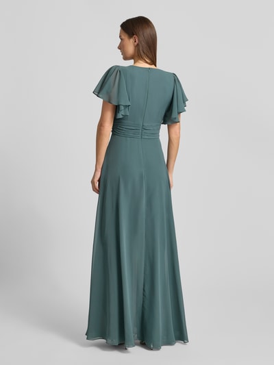 Frauenmodel trägt Jumpsuit mit V-Ausschnitt von Swing in gedecktem Blaugrün, fließender Stoff, tailliert, Rückansicht, Ganzkörperansicht.