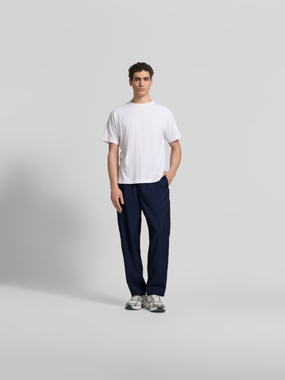 Männermodel trägt Straight Fit Sweatpants aus Viskose-Mix von Kenzo in Dunkelblau mit Cargo-Tasche, elastischem Bund und Tunnelzug, Ganzkörperansicht von vorne.