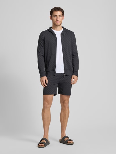 Männermodel trägt Sweatjacke mit Logo-Muster und Kapuze von JOOP! Collection, Reine Baumwolle, Regular-Fit, Ganzkörperansicht von vorne.