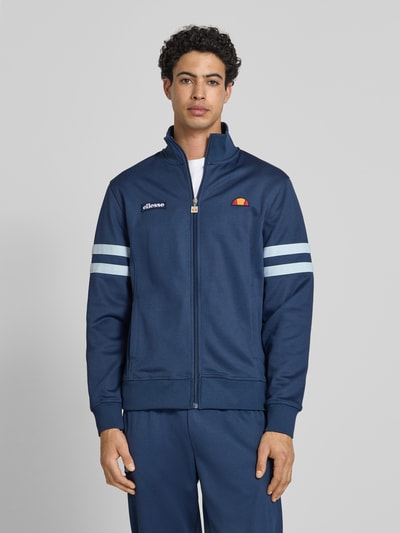 Mannenmodel draagt heren sweatjack van katoenmix, model 'ROMA' van Ellesse, recht pasvorm, opstaande kraag, steekzakken, labeldetails, geheel van voren gefotografeerd, frontale weergave van het bovenlichaam.
