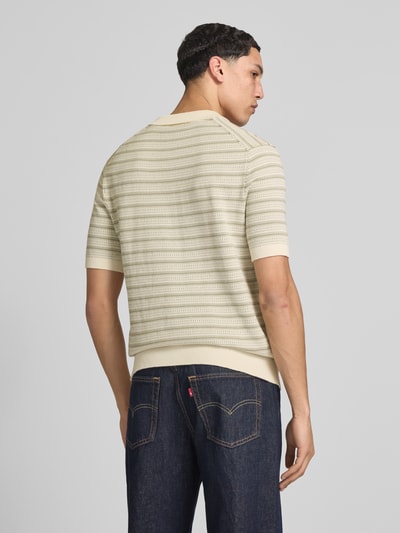 Männermodel trägt Regular Fit Poloshirt aus reiner Bio-Baumwolle Modell 'TILO' von Only & Sons mit Optik:Allover-Muster, Strick, Ganzkörperansicht Rückansicht.