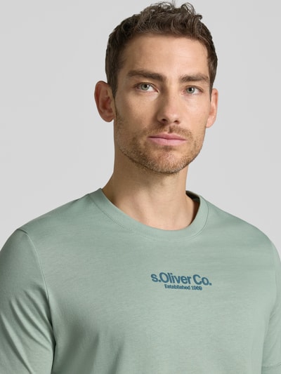 Männermodel trägt Regular Fit T-Shirt aus reine katoen van s.Oliver RED LABEL, effen, labelprint, ronde hals, korte mouw, Nahaufnahme Oberkörper.
