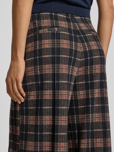 Frauenmodel trägt Wide Fit Stoffhose mit Viskose-Anteil Modell 'Kate' von ICHI, kariertes Muster in Schwarz und Rot, Nahaufnahme Rückansicht.