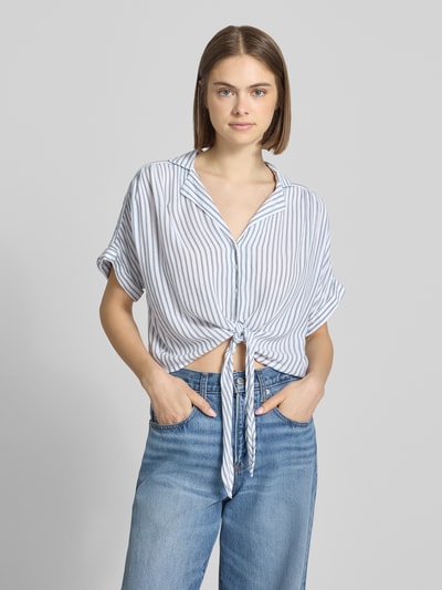 Frauenmodel trägt Regular Fit Hemdbluse aus reiner Viskose Modell 'PAULA' von Only, gestreift, kurzarm, V-Ausschnitt, Ganzkörperansicht von vorne.