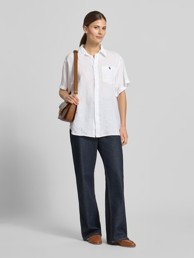 Frauenmodel trägt Oversized Hemdbluse aus reinem Leinen von Polo Ralph Lauren in Weiß, unifarben, mit Logo-Stitching, kurzarm, Brusttasche; Ganzkörperansicht von vorne.