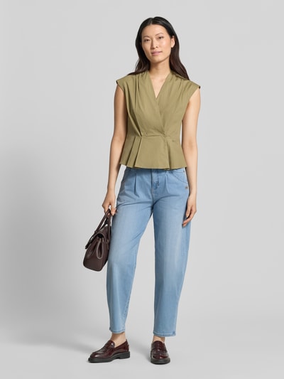 Kobiece model nosi Barrel Fit Jeans mit Label-Detail Modell 'Carlotta' von Gang, mieszanka bawełny z dodatkiem streczu, wpuszczane kieszenie, detal z logo, szerokość w rozmiarze 27: 38 cm, długość wewnętrzna nogawki w rozmiarze 27: 71 cm, jasnoniebieskie, gładka faktura, pełny widok z przodu.