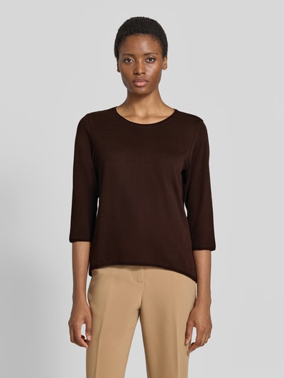 Frauenmodel trägt Regular Fit 3/4-Shirt aus reiner Baumwolle von s.Oliver RED LABEL in Dunkelbraun, kombiniert mit beigefarbener Hose, Ganzkörperansicht von vorne. Damen 3/4-Shirt von s.Oliver RED LABEL.