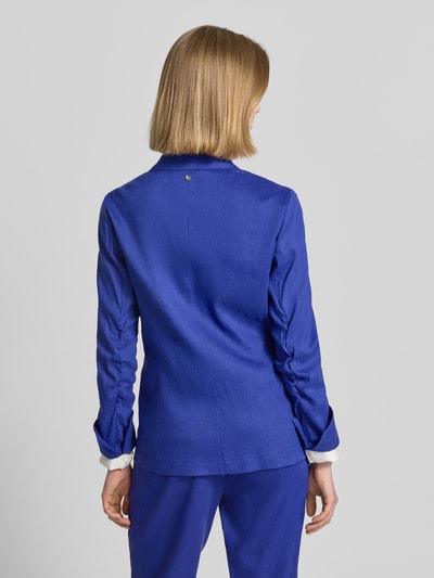 Frauenmodel trägt Blazer aus Leinen-Mix mit Reverskragen von Marc Cain, Taillierter Schnitt, Viskose-Anteil, Ganzkörperansicht Rückansicht.