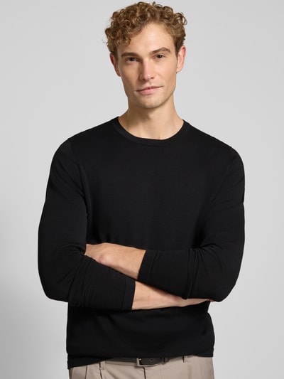 Männermodel trägt zwart slim fit shirt met lange mouwen van puur katoen van DRYKORN, ronde hals, ribboordjes, ruglengte maat M 70 cm, mouwlengte maat M 70 cm, Nahaufnahme Oberkörper.