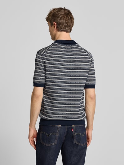 Männermodel trägt Regular Fit Poloshirt aus reiner Bio-Baumwolle Modell 'TILO' von Only & Sons, Optik:Allover-Muster, Strick, Ganzkörperansicht Rückansicht.