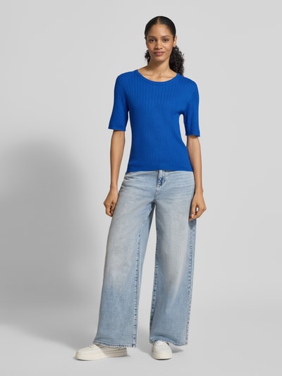 Frauenmodel trägt Sim Fit Strickpullover aus Viskose-Mix mit Zopfmuster von Christian Berg Woman Selection in Blau, Rippstrick, Ganzkörperansicht von vorne.
