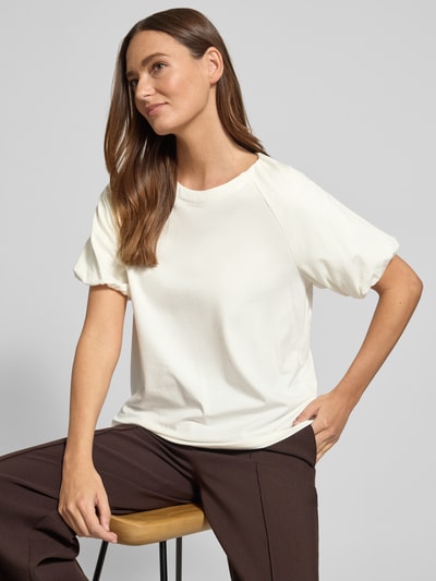 Vrouwenmodel draagt Regular Fit T-shirt met viscose model 'Ruffel' van Fynch-Hatton in crème, mix van viscose en katoen, ronde hals, logo, ruglengte bij maat S 57 cm, vooraanzicht bovenlichaam.
