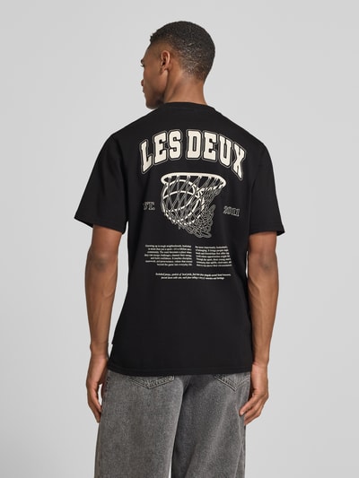 Männermodel trägt T-Shirt mit Label-Print Modell 'Brady whop' von Les Deux, reine Baumwolle, gerader Schnitt, Rückenlänge 72 cm, Ganzkörperansicht Rückansicht