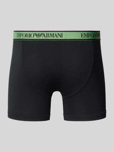 Produktfoto, schwarze Slim Fit Trunks aus Baumwoll-Mix von Emporio Armani mit grünem elastischem Bund und Logo-Detail.