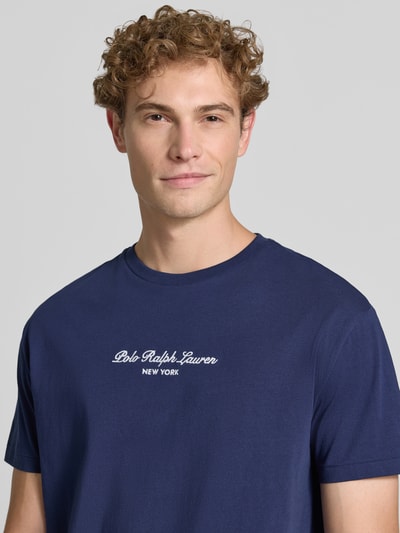 Männermodel trägt Regular Fit t-shirt aus puur katoen von Polo Ralph Lauren in donkerblauw, witte tekst, Nahaufnahme Oberkörper