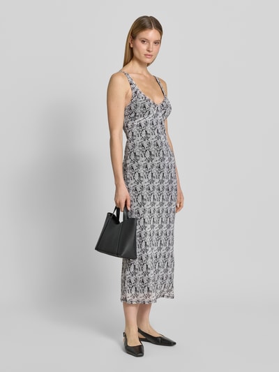 Frauenmodel trägt körpernahes Freizeitkleid mit Allover-Muster Modell 'STEPH' von Vero Moda, V-Ausschnitt, schmale Träger, gerade, Ganzkörperansicht von vorne.
