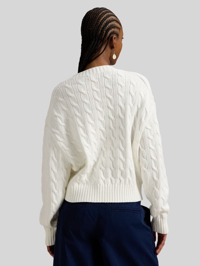 Modelka kobieca nosi Regular Fit Strickpullover aus reiner Baumwolle od Polo Ralph Lauren, biały sweter z plecionym wzorem i logo na plecach, krój regular fit, crew neck, długi rękaw, bawełniany materiał, widok całej sylwetki z tyłu.