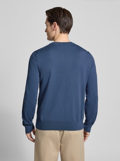 Männermodel trägt Regular Fit Strickpullover aus reiner Baumwolle Modell 'UPCAS' von BOSS in Unifarben, Ganzkörperansicht Rückansicht.
