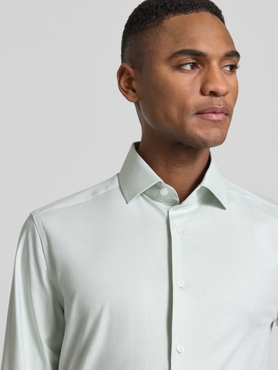 Męski model nosi Regular Fit Business-Hemd mit Kentkragen od OLYMP, bawełniana mieszanka ze stretchem, krój regular fit, model 'Global Kent', kołnierzyk kent, zapięcie na guziki, długość pleców w rozmiarze 40: 79 cm, szerokość ramion w rozmiarze 40: 46 cm, długość rękawa w rozmiarze 40: 65 cm, jasny kolor, gładka faktura, zbliżenie górnej części ciała