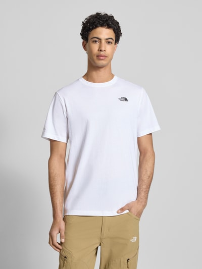 Mężczyzna nosi Regular Fit T-Shirt mit Logo-Stitching von The North Face, biały bawełniany T-shirt, okrągły dekolt, krój regular fit, długość tyłu w rozmiarze M: 70 cm, widok całej sylwetki z przodu.
