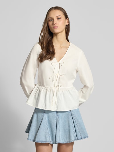 Frauenmodel trägt Slim Fit Langarmbluse aus reiner Baumwolle von Marc O’Polo Denim, unifarben, V-Ausschnitt, Schleifen, Ganzkörperansicht von vorne.