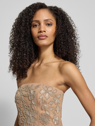 Vrouwenmodel draagt avondkleid im Off-Shoulder-Look van Adrianna Papell, beige met sierbesatz, getailleerd, detailopname bovenlichaam.