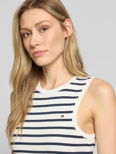 Vrouwenmodel draagt Slim Fit Tank Top uit pure katoen model 'SLIM CODY' van Tommy Hilfiger, gestreept patroon, logo-stiksel, ronde hals, brede bandjes, close-up bovenlichaam.