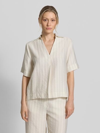 Frauenmodel trägt Regular Fit Hemdbluse aus Lyocell-Mix Modell 'MARIE' von Selected Femme in Creme mit Nadelstreifen, Optik:Allover-Muster, Johnny-Kragen, V-Ausschnitt, Rückenpasse mit Raffung, verdeckte Knopfleiste, Kurzarm, feine Struktur, Ganzkörperansicht von vorne.