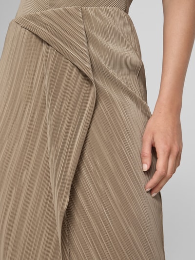Kobieta nosi spódnicę midi 'Enganliegender Midi-Rock mit Label-Applikation' od Calvin Klein Womenswear, efekt: jednolity kolor, krój: dopasowany, długość midi, aplikacja z metką, dół z rozporkiem, wykończenie materiału: plisowanie, zbliżenie na dolną część ciała
