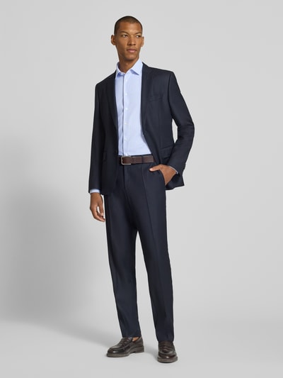 Männermodel trägt Slim Fit Businesshemd mit Kentkragen von Jake*s in Hellblau mit feinen Streifen, kombiniert mit dunkelblauem Anzug, Ganzkörperansicht von vorne.