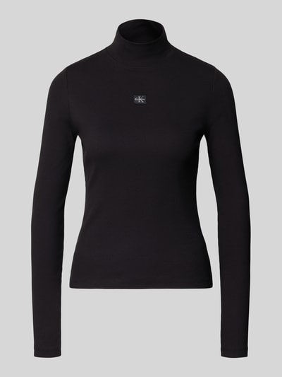 Produktfoto, Turtleneck-Pullover mit Label-Detail van Calvin Klein Jeans in het zwart, mix van katoen en elastaan, nauwsluitend model, opstaande kraag, labeldetail op de borst, ruglengte maat S 56 cm.