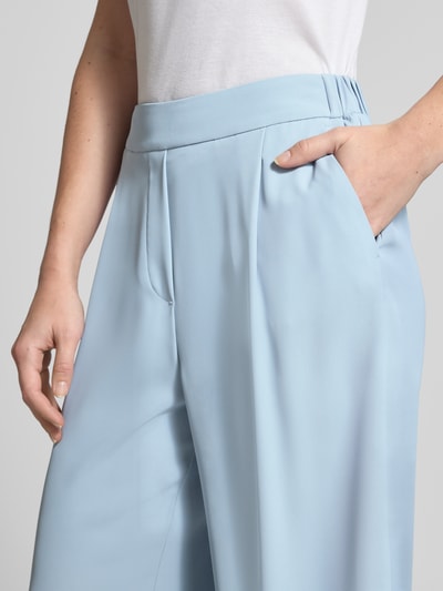 Frauenmodel trägt Stoffhose mit elastischem Bund von Jake*s Collection aus hellblauem Material-Mix mit Stretch-Anteil, gelegte Falten, Nahaufnahme Oberkörper.